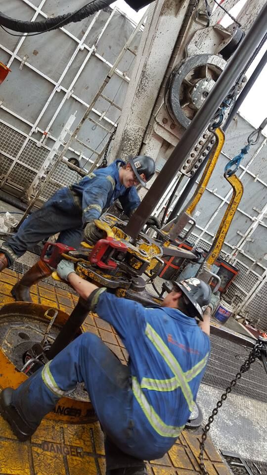 Workers using AAX Tong Release Handle Guard